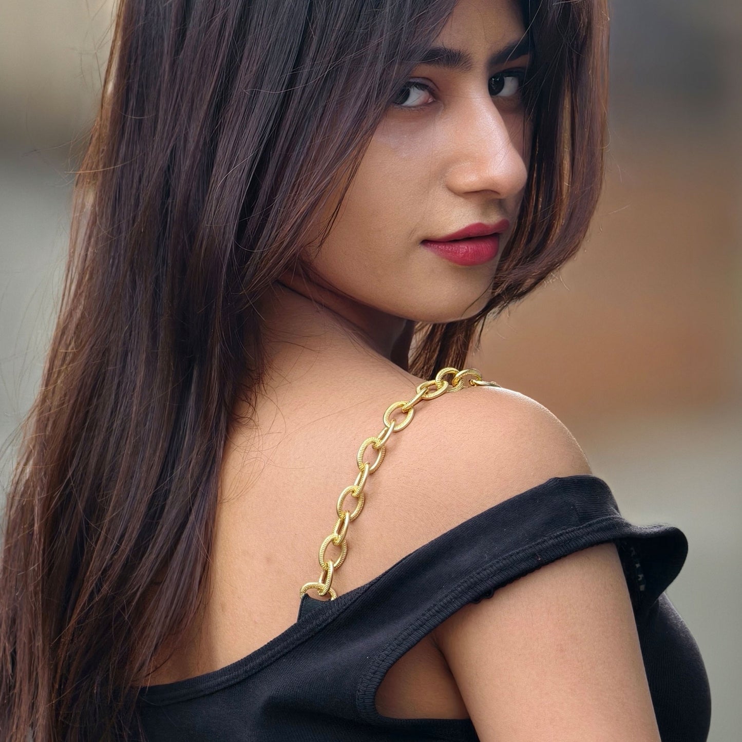 Woman with a gold chain strap